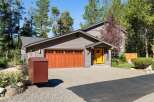 Charming home featuring a striking bright yellow front door that welcomes you into the property.