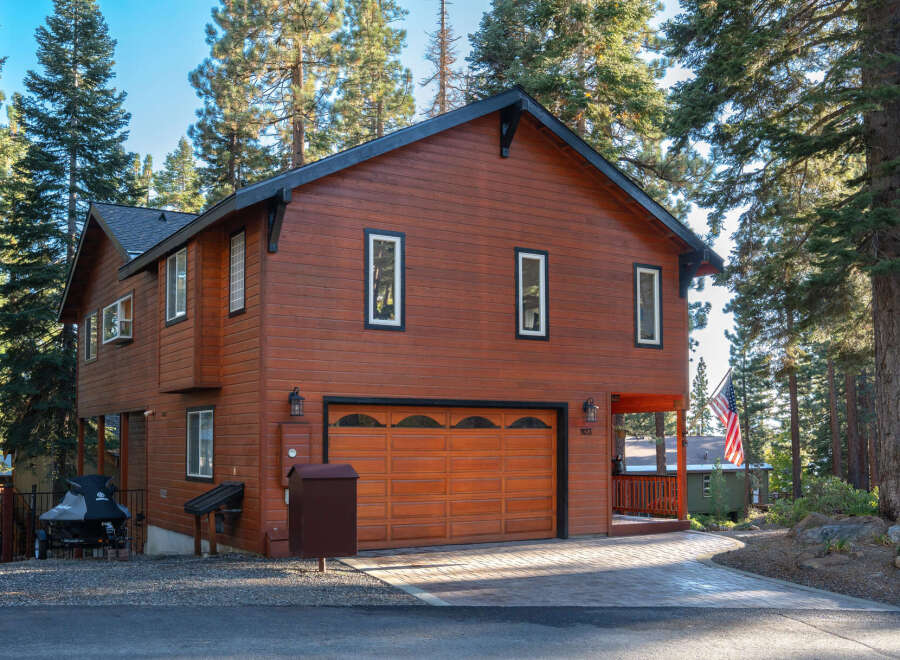 Discover this charming wooden home nestled among tall pine trees, offering a serene mountain retreat.