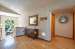 This charming entryway features a beautiful arched window offering serene views of the surrounding nature.