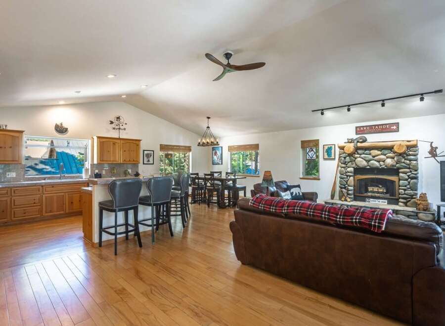 Experience the perfect blend of comfort and style in this spacious open-concept living area, featuring a gourmet kitchen with ample cabinet space and a large island with bar seating.
