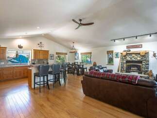 Experience the perfect blend of comfort and style in this spacious open-concept living area, featuring a gourmet kitchen with ample cabinet space and a large island with bar seating.