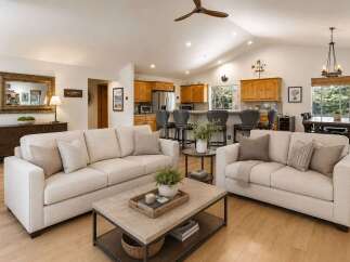 Experience open-concept living in this beautifully appointed home, featuring a spacious living area that seamlessly flows into a modern kitchen with a breakfast bar.
