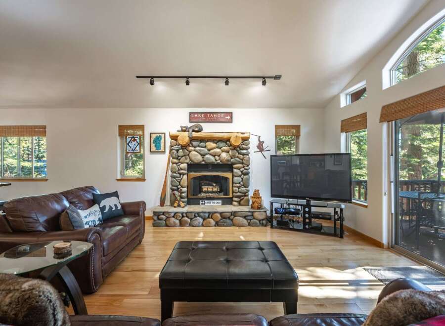 Experience rustic charm in this inviting living room, featuring a magnificent stone fireplace as the centerpiece.