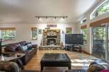 Experience rustic charm in this inviting living room, featuring a magnificent stone fireplace as the centerpiece.