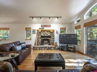 Experience rustic charm in this inviting living room, featuring a magnificent stone fireplace as the centerpiece.