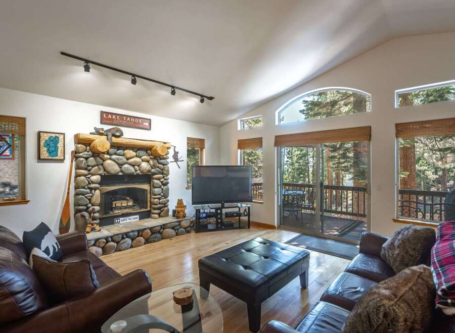 Experience rustic charm in this inviting living room, featuring a magnificent stone fireplace as the centerpiece.