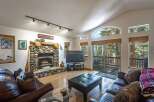 Experience rustic charm in this inviting living room, featuring a magnificent stone fireplace as the centerpiece.