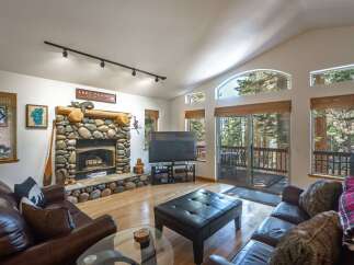 Experience rustic charm in this inviting living room, featuring a magnificent stone fireplace as the centerpiece.