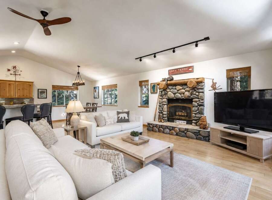 Experience rustic charm in this spacious living area, featuring a magnificent stone fireplace as the focal point.