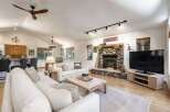 Experience rustic charm in this spacious living area, featuring a magnificent stone fireplace as the focal point.