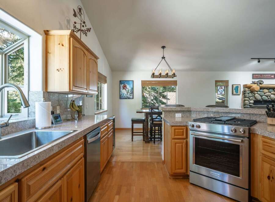 Discover this charming kitchen featuring warm wood cabinetry and granite countertops, perfect for culinary adventures.
