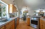 Discover this charming kitchen featuring warm wood cabinetry and granite countertops, perfect for culinary adventures.