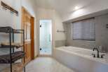 Experience luxury in this stunning bathroom featuring a spacious soaking tub and a separate glass-enclosed shower.