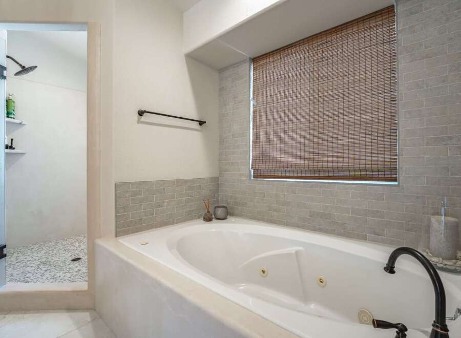 Indulge in relaxation in this luxurious bathroom featuring a spacious jetted tub perfect for unwinding after a long day.