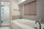 Indulge in relaxation in this luxurious bathroom featuring a spacious jetted tub perfect for unwinding after a long day.