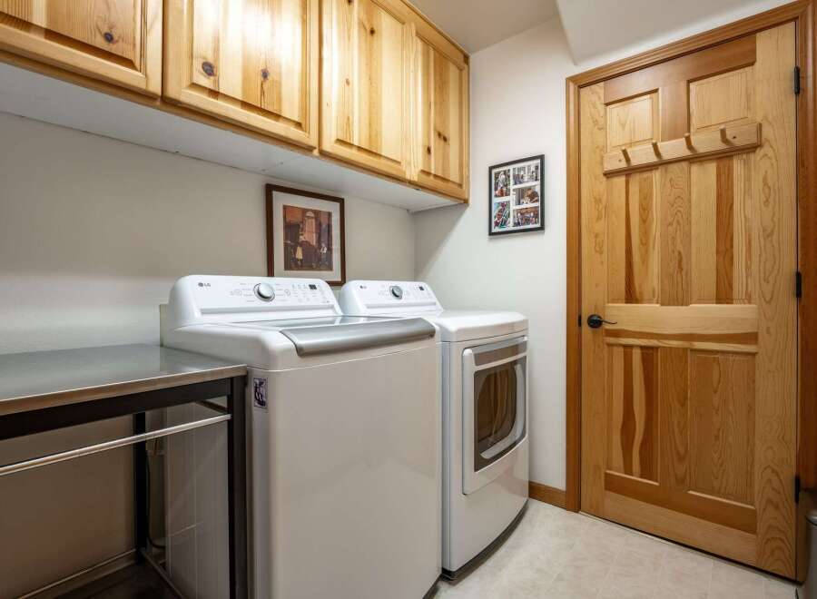 This laundry room features a stacked LG washer and dryer set, perfect for maximizing space.