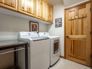 This laundry room features a stacked LG washer and dryer set, perfect for maximizing space.
