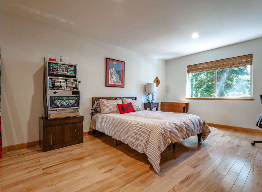 This unique bedroom features a vintage slot machine, perfect for a game room or a fun-themed space.