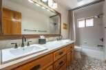 This charming bathroom features a spacious double vanity with ample counter space and storage, perfect for busy mornings.