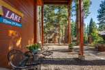 Enjoy the serene mountain setting from this charming porch, complete with rustic wooden beams and a cozy seating area.