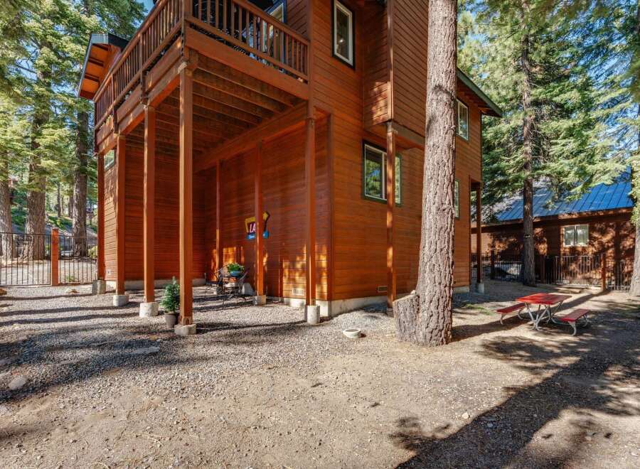Experience the charm of this rustic wooden home nestled amongst tall pine trees.