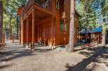 Experience the charm of this rustic wooden home nestled amongst tall pine trees.