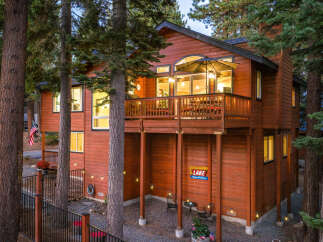 Experience the ultimate mountain getaway in this stunning wooden home, nestled amongst towering pine trees.