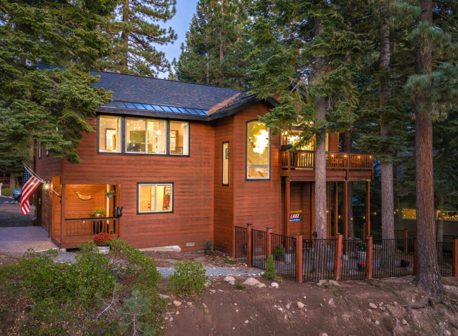 Nestled amidst towering pine trees, this stunning wooden home offers a serene mountain retreat.