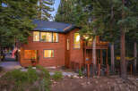 Nestled amidst towering pine trees, this stunning wooden home offers a serene mountain retreat.