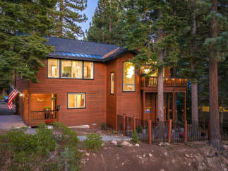Nestled amidst towering pine trees, this stunning wooden home offers a serene mountain retreat.