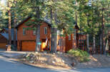 Nestled among tall pine trees, this charming wooden home offers a warm and inviting atmosphere.