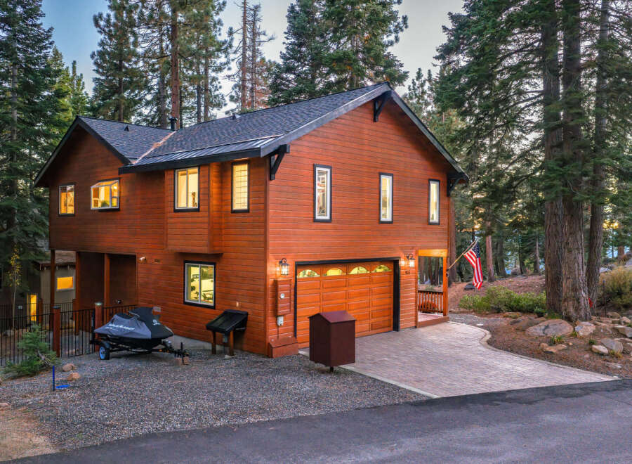 Experience mountain living in this stunning wood-sided home, nestled amongst tall pine trees.