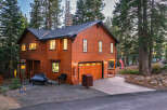 Experience mountain living in this stunning wood-sided home, nestled amongst tall pine trees.
