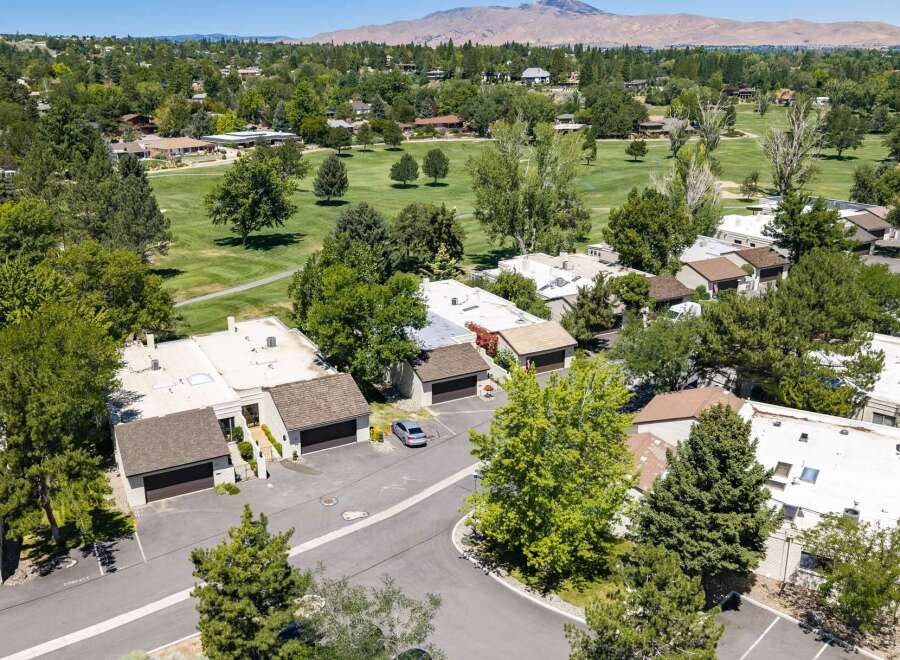 Discover this stunning property nestled beside a lush golf course, offering breathtaking mountain views in the distance.