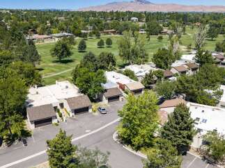 Discover this stunning property nestled beside a lush golf course, offering breathtaking mountain views in the distance.