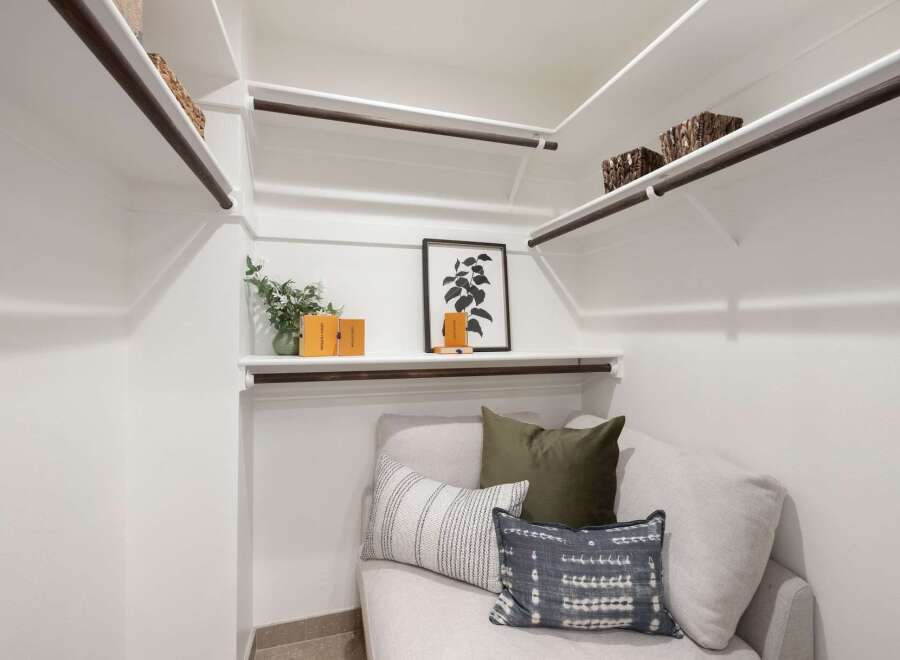 Discover the ultimate in organization and style with this spacious walk-in closet, featuring ample shelving and hanging space.