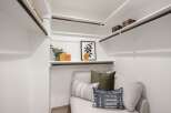 Discover the ultimate in organization and style with this spacious walk-in closet, featuring ample shelving and hanging space.