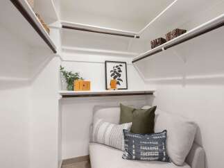 Discover the ultimate in organization and style with this spacious walk-in closet, featuring ample shelving and hanging space.