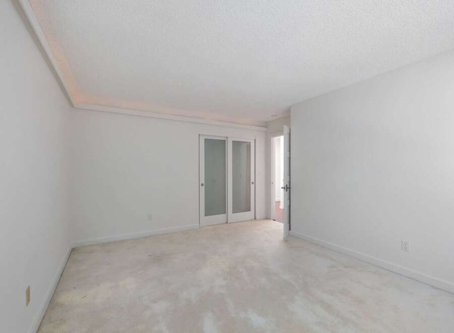 This spacious room features a neutral color palette, creating a serene and versatile atmosphere.