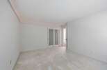 This spacious room features a neutral color palette, creating a serene and versatile atmosphere.