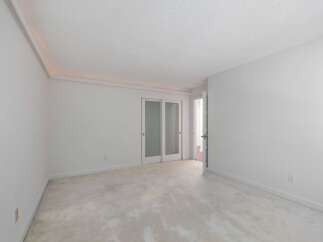 This spacious room features a neutral color palette, creating a serene and versatile atmosphere.