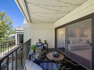 Enjoy outdoor living on this charming balcony, perfect for relaxing or entertaining.