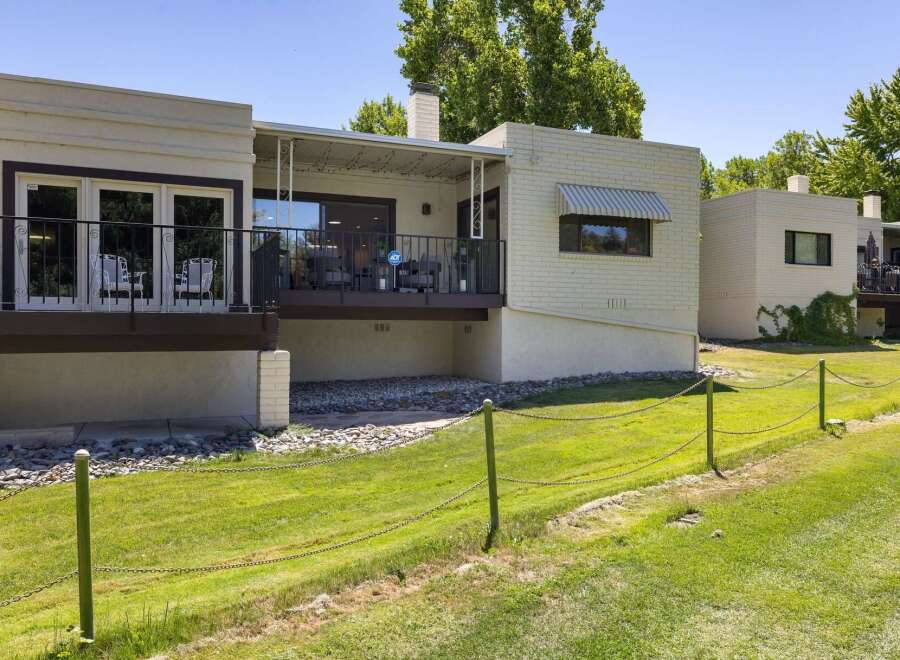 Enjoy outdoor living on the spacious deck overlooking a lush green lawn, perfect for relaxation and entertaining.
