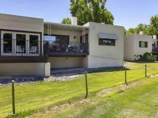 Enjoy outdoor living on the spacious deck overlooking a lush green lawn, perfect for relaxation and entertaining.