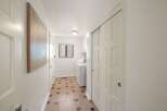 Discover a bright and airy hallway featuring a convenient laundry area with a washer and dryer.