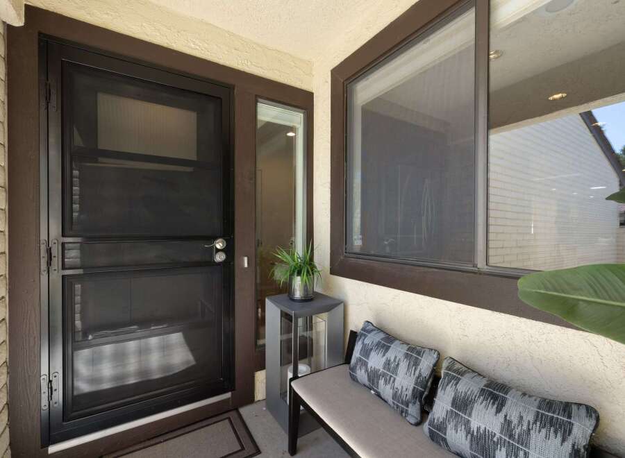Enhance your home's curb appeal with a stylish screen door, perfect for allowing fresh air while keeping insects out.