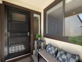 Enhance your home's curb appeal with a stylish screen door, perfect for allowing fresh air while keeping insects out.