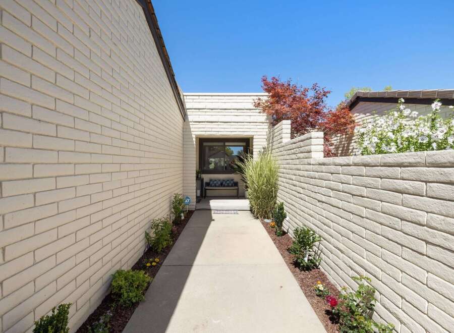 Welcome guests through this charming walkway leading to the entrance of your home.