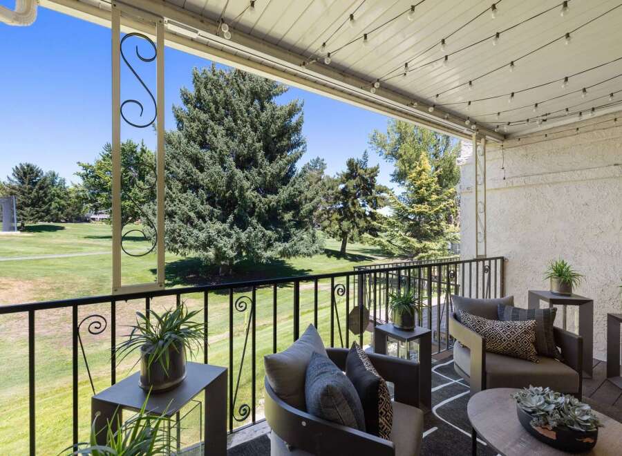 Enjoy your morning coffee or evening relaxation on this charming balcony overlooking a lush green golf course.