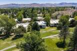 Experience luxury living with this stunning aerial view of homes nestled beside a pristine golf course.